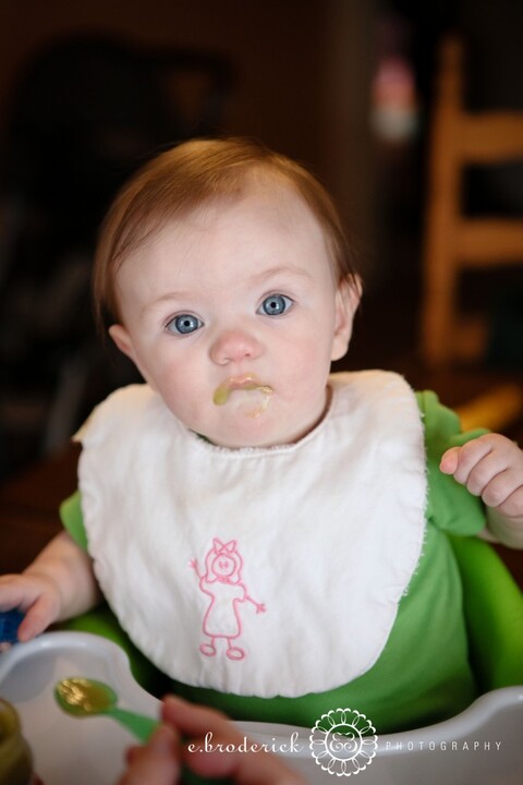 Not so sure she likes those peas! 