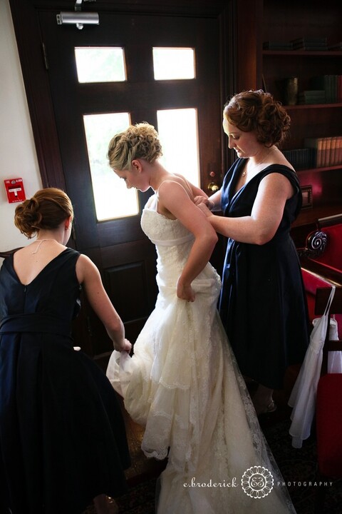 Lindsay and Ryan's sister, Meghan, help the bride into her dress. One of my favorite parts of every wedding day!
