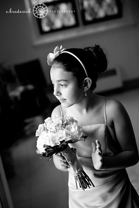 Their junior bridesmaid watches as Patty arrives just outside the church's doors.